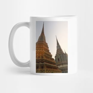 Third view of two stupa against sky at Wat Pho Mug